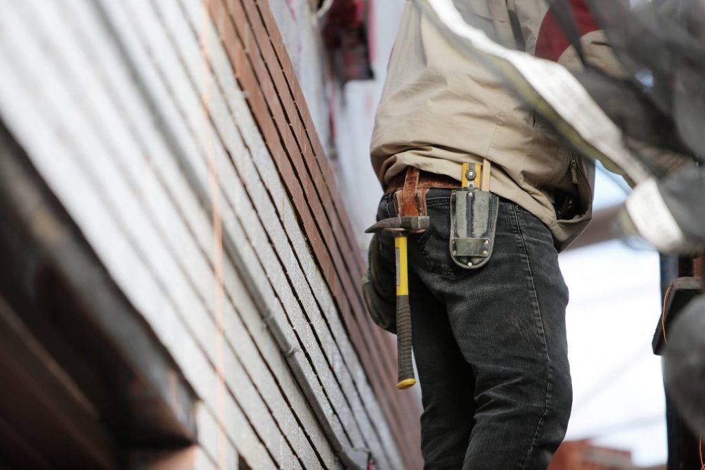 a contractor, lower half, wearing tool belt