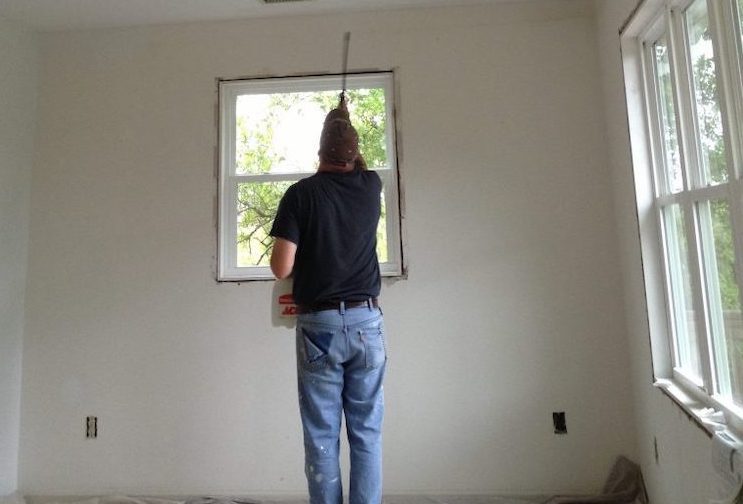 professional painter painting white wall